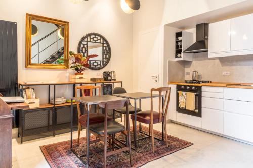 a kitchen with a table and chairs in a room at Tolomeo Apartment in Rome