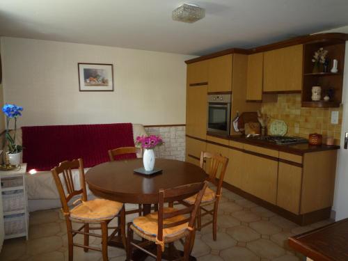 une cuisine et une salle à manger avec une table et des chaises dans l'établissement 6 Rue Des Eglantines, à Saint-Malo