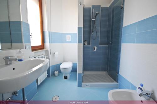 Un baño azul y blanco con lavabo y ducha. en B&B Vanvitelli, en Caserta