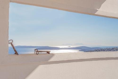 a bench sitting on the beach looking out at the ocean at Peaceful apartment with beautiful view in Hvar