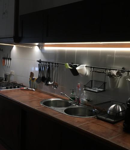 a kitchen counter with two sinks and utensils at La Casa del Trafalgar in Los Caños de Meca