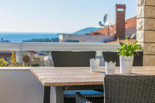 a wooden table and chairs on a balcony at Peaceful apartment with beautiful view in Hvar
