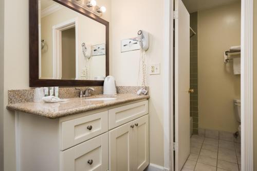 a bathroom with a sink and a mirror at Bokai Garden Hotel in Rosemead