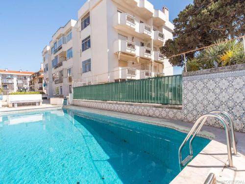 a swimming pool in front of a apartment building at Parede Ocean in Parede