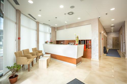a lobby with chairs and a counter in a building at Hotel Mar Garni in Belgrade