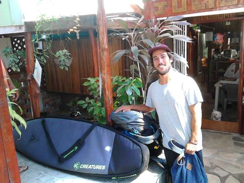 a man is standing next to a motorcycle at Hostel Julieta in Rivas