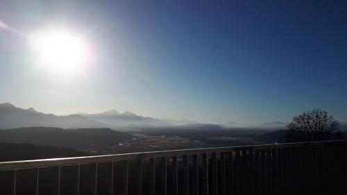 a view of the mountains with the sun in the sky at Südalpen Lofts in Bleiburg