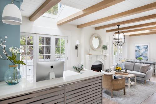 a kitchen with a living room with a fireplace at Hideaway Santa Barbara, A Kirkwood Collection Hotel in Santa Barbara