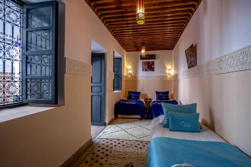 a room with two beds and a window at Riad Ciel d'Orient in Marrakesh