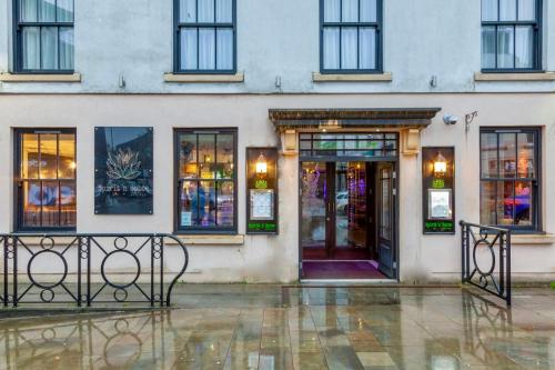 a facade of a building with a glass door at The BlueBell Hotel in Neath