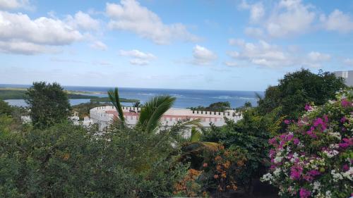 a view of a building with trees and flowers at Villa Sans Souci in Vieux Fort