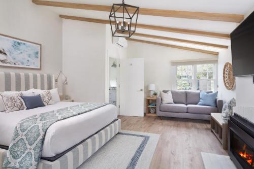 a bedroom with a bed and a fireplace at Hideaway Santa Barbara, A Kirkwood Collection Hotel in Santa Barbara
