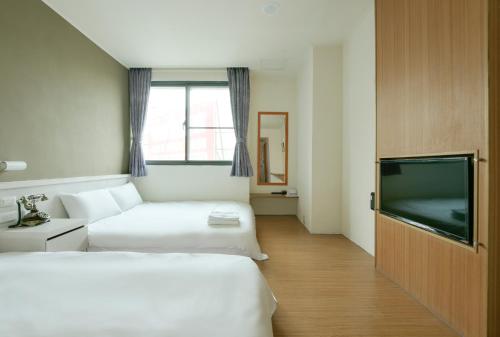 Postel nebo postele na pokoji v ubytování Raise Hotel Taichung