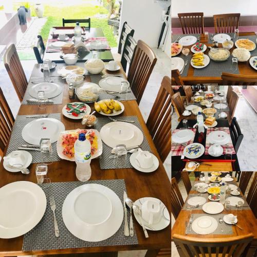 a long table with plates of food on it at White Villa Airport Transit Hotel in Katunayake