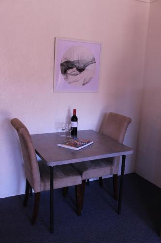 a table that has a bottle of wine on it at Childers Gateway Motor Inn in Childers