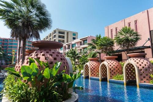 a resort with a pool with a bunch of vases at Marrakesh Huahin 4bedrooms suite with Jacuzzi 208 in Hua Hin