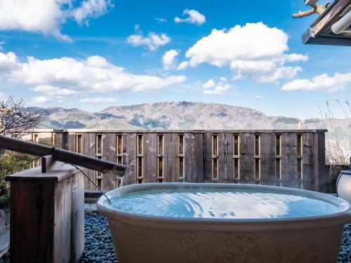 a hot tub with a view of the mountains at Shirayunoyado Yamadaya Hakone Gora in Hakone