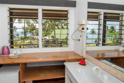 a kitchen with a window and a sink and a tub at Crusoe's Retreat - Family Friendly in Namanggumanggua