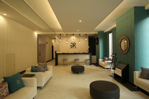 a lobby with couches and a bar in the background at Green Rich Hotel & Capsule Naha - Artificial hot spring Futamata Yunohana in Naha