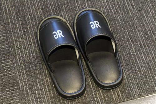 a pair of black shoes with the rr on them at Green Rich Hotel & Capsule Naha - Artificial hot spring Futamata Yunohana in Naha