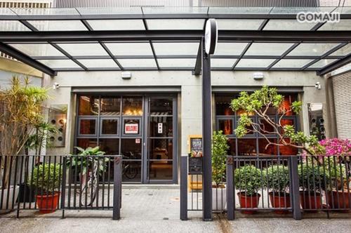 a store with plants in front of a building at 108 House Inn in Tainan