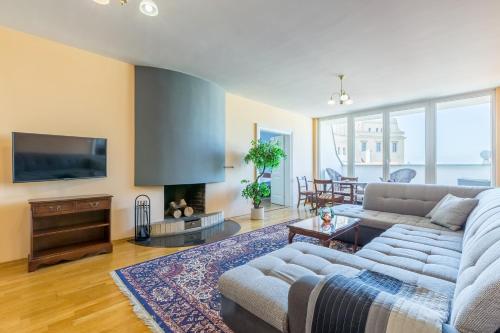 a living room with a couch and a tv at Hotel U Rytíře in Mělník