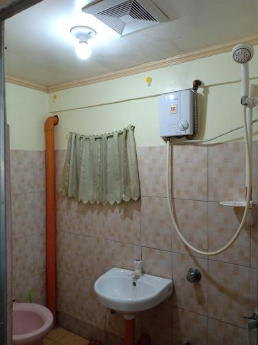 a bathroom with a sink and a shower at A.C. Asistin Transient House in Baguio