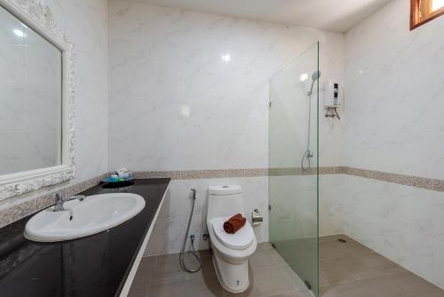 a bathroom with a toilet and a sink and a shower at Baan Karon Hill Phuket Resort in Karon Beach