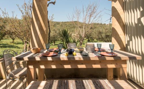 a wooden table with food on it on a patio at Ag Thekla Est 1924 in Skinária