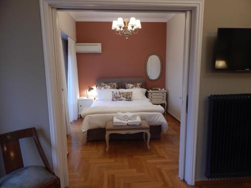 a bedroom with a large bed and a mirror at Athens-Plaka, Peter’s beautiful apartment in Temple of Zeus in Athens
