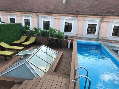 a balcony with a swimming pool in a building at Boutique hotel Tvrđa in Osijek