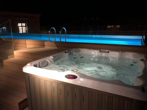 a jacuzzi tub on a deck at night at Boutique hotel Tvrđa in Osijek
