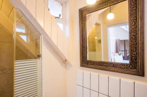 a mirror on a wall next to a staircase at Karen Gables in Nairobi