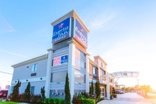 a building with a sign on the top of it at Express Inn - Spring in Spring