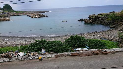 a person standing next to a body of water at Haven Seaview Homestay in Lanyu