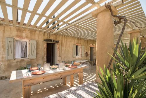 a patio with a table with plates of food on it at Ag Thekla Est 1924 in Skinária