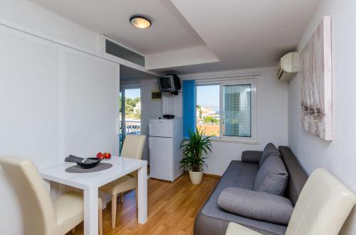 a living room with a couch and a table at Apartments Lorena Mljet in Pomena