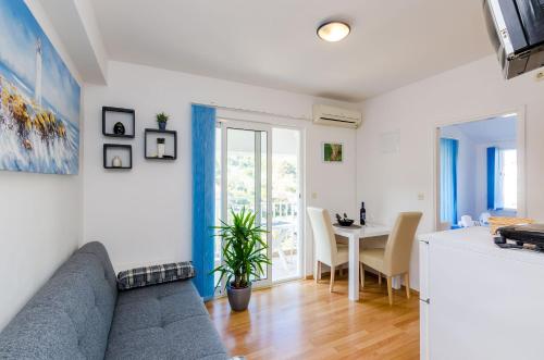 a living room with a couch and a table at Apartments Lorena Mljet in Pomena