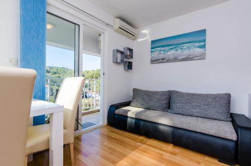 a living room with a couch and a window at Apartments Lorena Mljet in Pomena