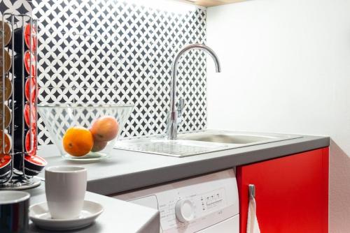 a kitchen with a sink and oranges on a counter at Deco city center apartment in Heraklio
