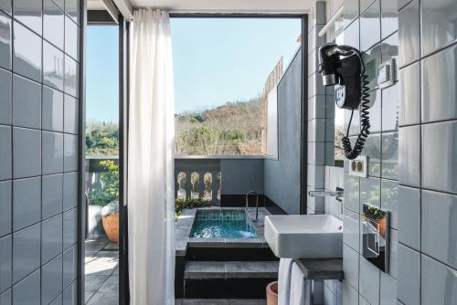 a bathroom with a sink and a view of a pool at Hotel Brummell in Barcelona