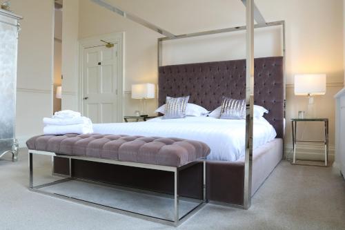 a large bedroom with a large bed with a large canopy bed sidx sidx at Winstanley House in Leicester