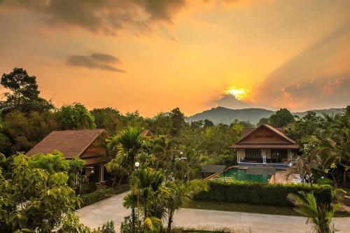 a sunset over a villa with a resort at Oscar Villa Aonang Krabi in Ao Nang Beach