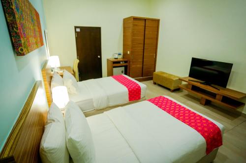 Postel nebo postele na pokoji v ubytování Aava Malacca Hotel