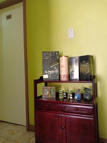 a wooden shelf with books on it in a room at A.C. Asistin Transient House in Baguio