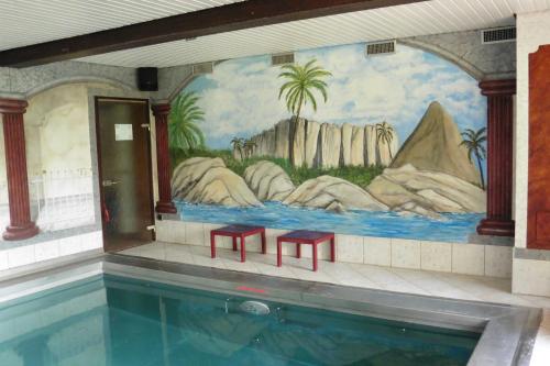 a pool with two red benches and a mural at Gasthof _ Pension _ Drei Linden in Pegnitz