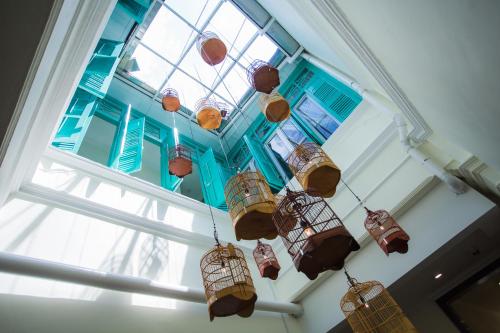a bunch of bird cages hanging from a ceiling at Aava Malacca Hotel in Melaka