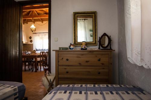 a bedroom with a dresser and a mirror on the wall at Feggaropetra by the Sea(Moonstone) - Trani Ammouda in Ormos Panagias
