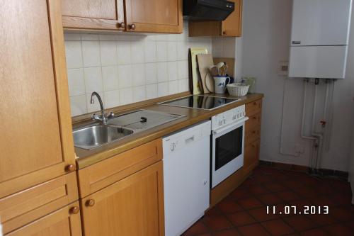 a small kitchen with a sink and a stove at Gästehaus am Krähenteich in Lübeck