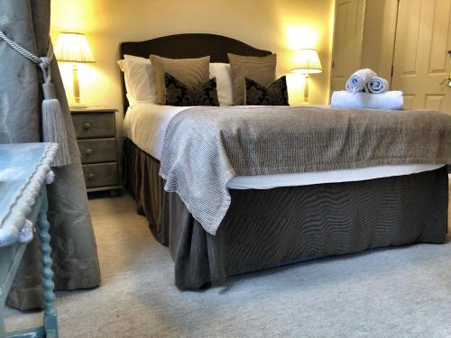 a bedroom with a bed with a stuffed animal on it at The Arran Lodge & Arran Sleep Huts in Lamlash